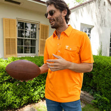 Load image into Gallery viewer, Man holding football outdoors wearing orange Tennessee Volunteers polo shirt with chest pocket