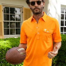 Load image into Gallery viewer, Man holding Wilson football wearing Tennessee Volunteers orange polo shirt with chest pocket logo