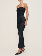 Load image into Gallery viewer, Model wearing high-rise cropped bootcut coated jeans with strapless top and slingback heels, side view