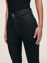 Load image into Gallery viewer, Close-up detail of high-rise black coated skinny crop jeans on model, showing waistband and front pocket