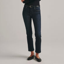 Load image into Gallery viewer, Model wearing dark indigo ankle-length straight leg jeans with black belt and flats