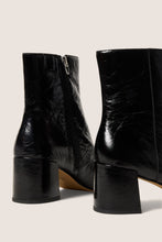 Load image into Gallery viewer, Rear view of black patent leather ankle boots with block heel and zipper closure