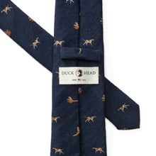 Load image into Gallery viewer, Duck Head navy wool silk tie featuring embroidered hunting dog and pheasant motifs, folded to show label