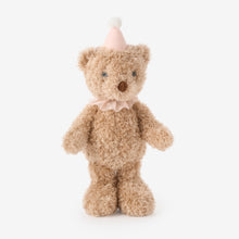 Load image into Gallery viewer, Fluffy tan teddy bear plush toy wearing a pink party hat and bow collar