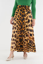 Load image into Gallery viewer, Model wearing a maxi-length leopard print A-line skirt with a high waistband and side slit