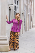 Load image into Gallery viewer, Model wearing a flowing leopard print maxi skirt paired with a purple blazer outdoors