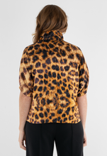 Load image into Gallery viewer, Back view of a leopard print blouse with puff sleeves and turtleneck collar on model