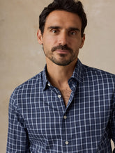 Load image into Gallery viewer, Male model wearing a navy plaid button-up shirt with white check pattern, collar open