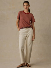 Load image into Gallery viewer, Model wearing wide-leg cream denim pants with brown belt and striped top, full-length view