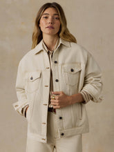 Load image into Gallery viewer, Woman wearing an oversized cream denim trucker jacket with contrast stitching and button front