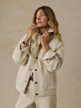 Load image into Gallery viewer, Model wearing an oversized cream denim jacket with contrast stitching and button front closure