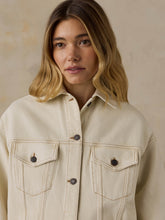 Load image into Gallery viewer, Woman wearing an oversized cream denim jacket with contrast stitching and button chest pockets