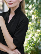 Load image into Gallery viewer, Close-up detail of a woman wearing a black short sleeve dress with mandarin collar