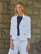 Load image into Gallery viewer, Woman wearing a white double-breasted cropped peacoat with gold buttons over navy top