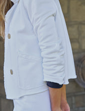 Load image into Gallery viewer, Close-up detail of white peacoat showing patch pocket, buttons, and rolled sleeve