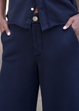 Load image into Gallery viewer, Close-up detail of navy wide-leg cropped sweatpant with side pockets and relaxed fit