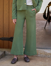 Load image into Gallery viewer, Model wearing wide-leg cropped sweatpant trousers with matching green blazer and brown loafers