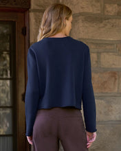 Load image into Gallery viewer, Back view of woman wearing navy cropped long-sleeve sweatshirt cardigan with brown pants