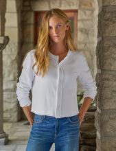 Load image into Gallery viewer, Model wearing a white button-front long-sleeve cardigan sweatshirt with jeans outdoors