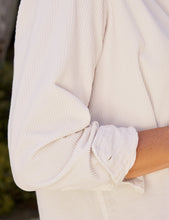 Load image into Gallery viewer, Close-up detail of rolled cuff and ribbed texture on a relaxed white corduroy button-up shirt