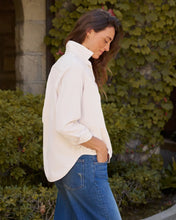 Load image into Gallery viewer, Woman wearing relaxed button-up corduroy shirt tucked into blue jeans, side profile view outdoors