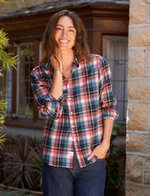 Load image into Gallery viewer, Woman smiling outdoors wearing a relaxed plaid button-up shirt with rolled sleeves and jeans