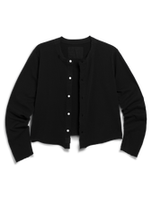 Load image into Gallery viewer, Black collarless cardigan jacket with white snap buttons and long sleeves, laid flat