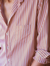 Load image into Gallery viewer, Close-up detail of striped button-up shirt showing chest pocket and rolled sleeve cuff
