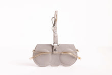 Load image into Gallery viewer, Gray leather eyeglass holder case with gold clip and round lens cutouts holding sunglasses