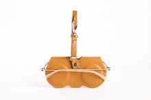 Load image into Gallery viewer, Tan leather eyeglass case with wrist strap handle and clear glasses tucked inside