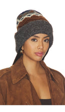 Load image into Gallery viewer, Model wearing a grey fairisle knit beanie with brown suede jacket, three-quarter view
