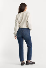 Load image into Gallery viewer, Back view of model wearing straight-leg dark wash jeans with cream sweatshirt and loafers