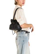 Load image into Gallery viewer, Model wearing Hammitt Gianna bucket bag on shoulder, styled with cream shirt and light wash jeans