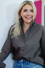 Load image into Gallery viewer, Woman smiling wearing a dark brown button-front ruffle collar long-sleeve shirt with jeans
