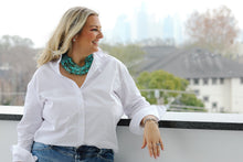 Load image into Gallery viewer, Woman wearing a white button-down shirt with ruffle collar, leaning on rooftop railing with city skyline behind