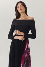 Load image into Gallery viewer, Model wearing off-shoulder long-sleeve black dress with pleated floral-print skirt panel