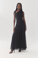Load image into Gallery viewer, Model wearing a black ruched sleeveless maxi dress with asymmetric neckline and flowy mesh skirt