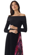 Load image into Gallery viewer, Model wearing off-shoulder long-sleeve black crop top with pleated floral midi skirt