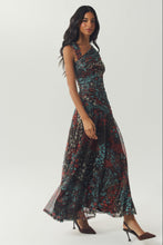 Load image into Gallery viewer, Model wearing a floral maxi dress with ruched bodice and flowing A-line skirt