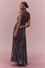 Load image into Gallery viewer, Model wearing a floral maxi dress with ruched bodice, shown from the back