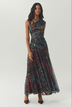 Load image into Gallery viewer, Model wearing a ruched floral maxi dress with asymmetric neckline and flared skirt