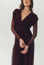 Load image into Gallery viewer, Model wearing a long-sleeve ruched mesh wrap-style evening gown with V-neckline