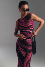 Load image into Gallery viewer, Model wearing a ruched sleeveless top with bold wavy abstract print, styled with sunglasses and beaded bag