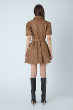 Load image into Gallery viewer, Back view of faux leather mini dress with puff sleeves, belted waist, and flared skirt