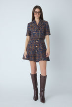 Load image into Gallery viewer, Model wearing a cropped boucle jacket with matching mini skirt and knee-high brown boots