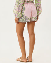 Load image into Gallery viewer, Back view of high-rise paisley-print chiffon shorts with coordinating long-sleeve top and gold sandals