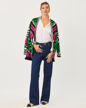 Load image into Gallery viewer, Model wearing open-front jacquard cardigan with tropical pattern over white shirt and jeans