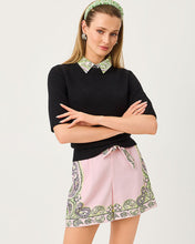 Load image into Gallery viewer, Model wearing black short-sleeve crewneck sweater layered over printed collared shirt with pink shorts