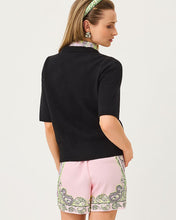 Load image into Gallery viewer, Back view of model wearing black short-sleeve knit sweater with pink paisley shorts and headband