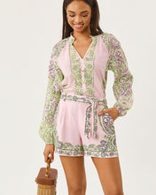 Load image into Gallery viewer, Model wearing a long-sleeve pink and green printed romper with tie waist and shorts